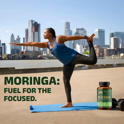 Woman practicing yoga with a Moringa supplement bottle on a rooftop with city skyline in the background