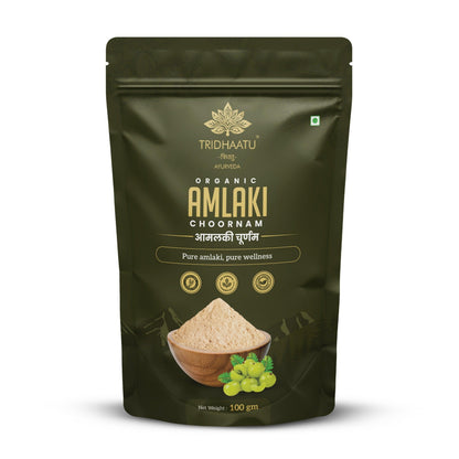 Tribhuvan Organic Amlaki Chodiram packaging with amlaki fruits and powder on a wooden board.